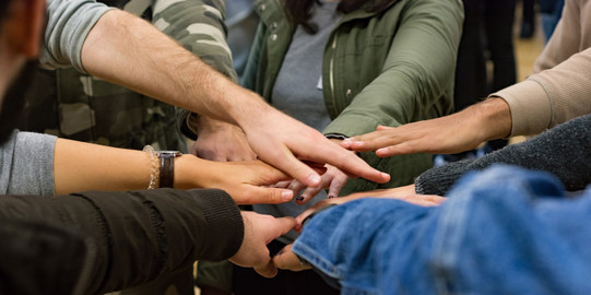 different hands on top of each other