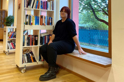 Young person sitting inside the IBZ foyer