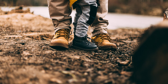 Feet of an adult and a child