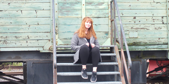 Lydia is sitting on steps